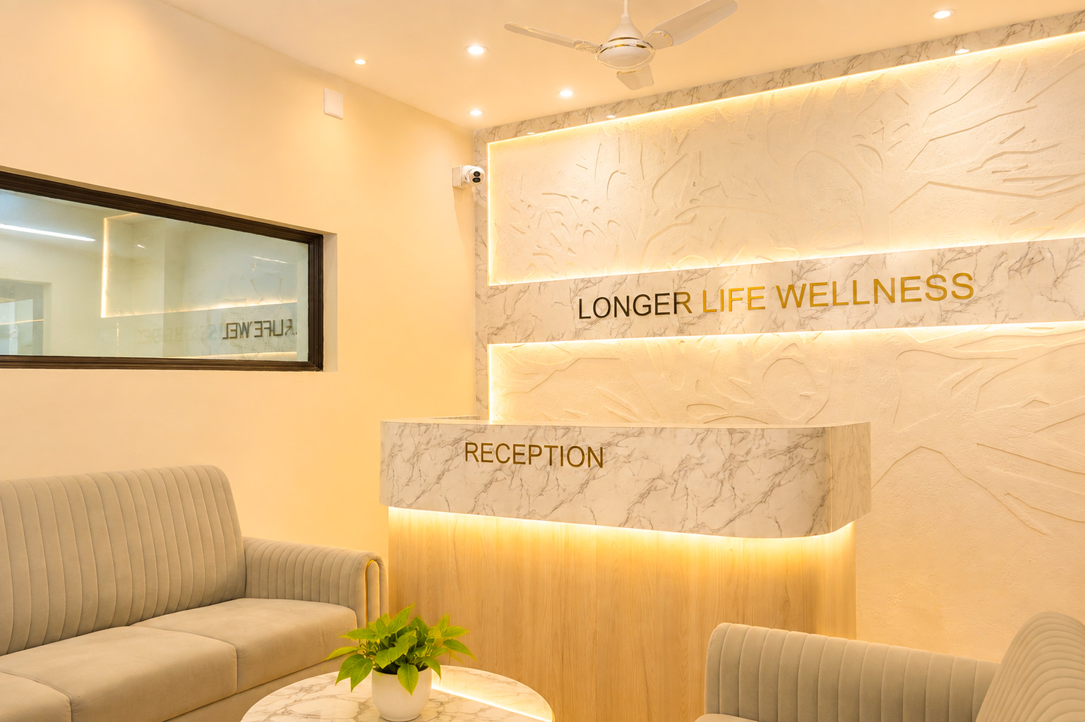Longer Life Wellness reception with marble desk and warm lighting