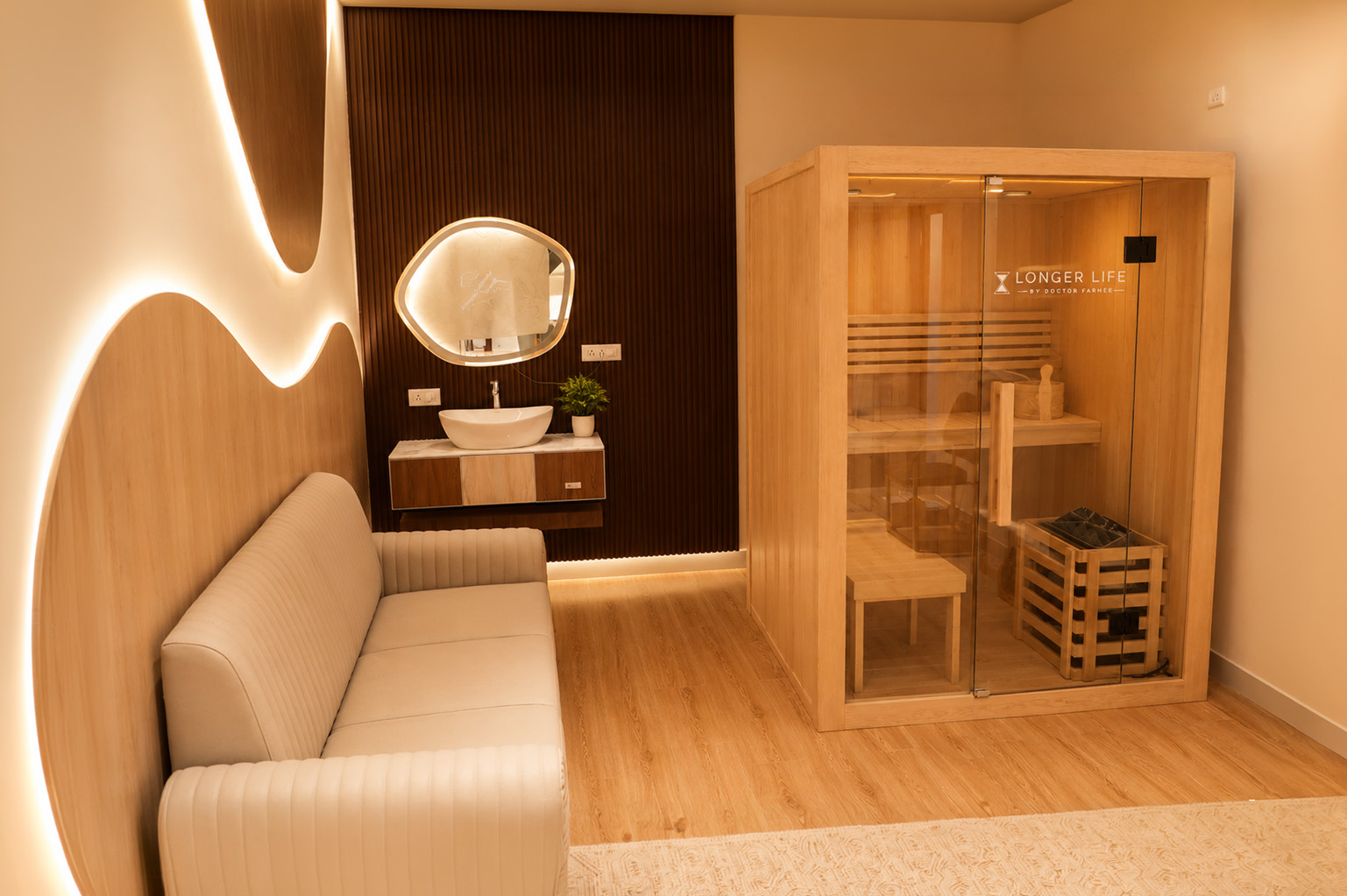 Recovery lounge with infrared sauna cabin, soft lounge seating and warm lighting